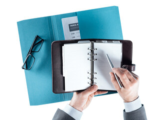 Businessman checking schedule on the organizer
