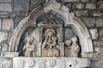 15th century scene of Madonna and Child flanked by St Tryphon and St Bernard on the entry through the Sea Gate to the Old Town of Kotor, Montenegro