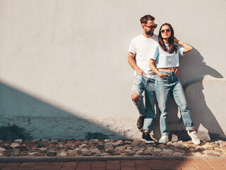 Smiling beautiful woman and her handsome boyfriend. Woman in casual summer jeans clothes. Happy...