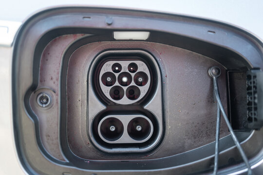 The electricity charging socket with AC type 2 and DC CSS2 of the ev car, technology of the transportation. Close-up and selective focus.