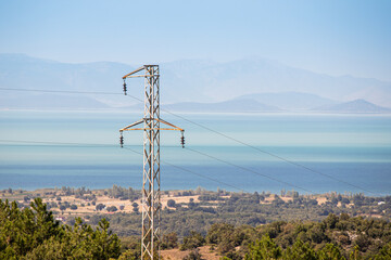 Obraz premium An electric pole with lines and cables for transmitting energy to consumers in wildlife reserve