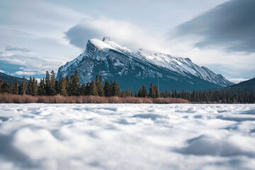 Fototapeta na wymiar Frozen Vermillion Lake with Mount Rundle and snow covered in winter on sunny day at Banff national park