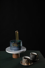 delicious cake for the holiday with candles two cups of coffee dessert sweets delicious food