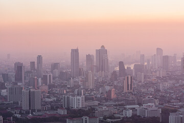 Naklejka na ściany i meble Bad air pollution in City. PM 2.5 dust in Bangkok or center city, Capital city are covered by heavy smog, Misty morning and sunrise in downtown with bad air pollution, Place to risk of cancer,Thailand