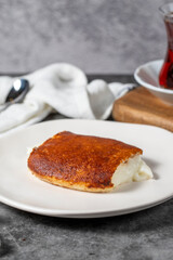 Milky dessert or Kazandibi. Traditional Turkish cuisine desserts. Kazandibi on a dark background. Close up