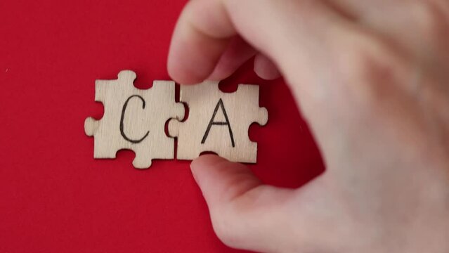 CAD word written on wooden puzzles on red background. Healthcare conceptual for hospital, clinic and medical busines. CAD acronym Coronary artery disease