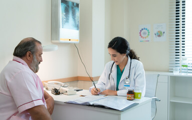 A female doctor examines the disease and gives advice on taking medication. for elderly patients receiving treatment