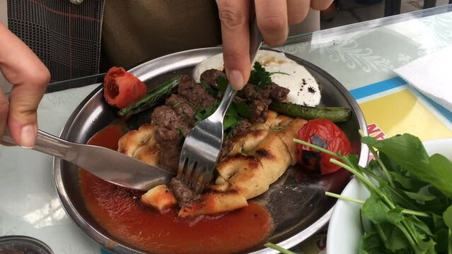 Eating Turkish kebab d&ouml;ner with bread and yoghurt