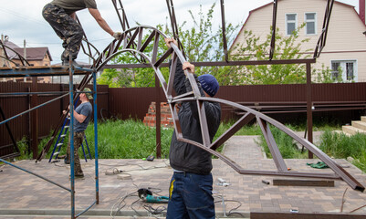 The worker installs the metal on the canopy.