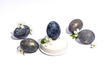 Easter egg on a beton stand isolated on white background. Traditional symbol, blooming cherry