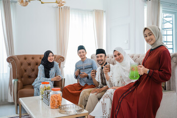 togetherness of Asian Muslim friends while celebrating Idul Fitri in the living room
