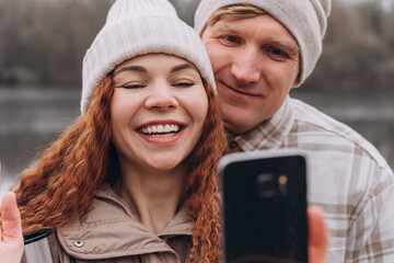30-35 couple in love making selfie or video call while walking