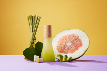 Mockup scene for products with empty glass bottle, fresh pink pomelo, green leaves and fresh...