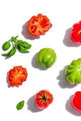 Green and red ribbed tomatoes isolated on white background. American or Florentine variety