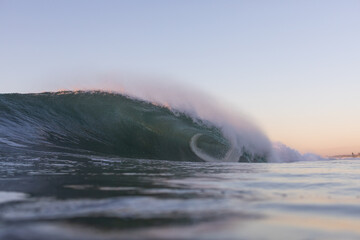 huge big wave breaking on a beach, copy space and no people