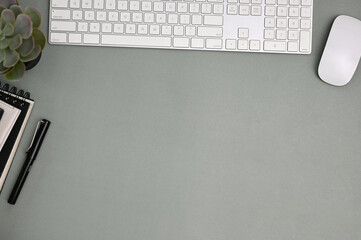 Modern minimal office desk workspace top view with copy space on grey background.