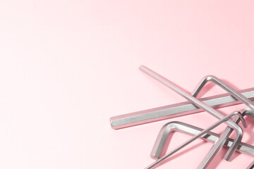 allen wrenches on pink background