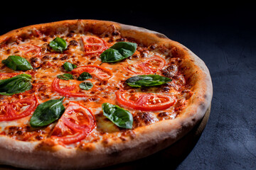 Delicious fragrant pizza with mozzarella, tomatoes and basil with tomato sauce - Margherita