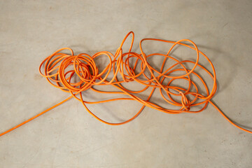 Tangled orange electrical cord, impossible problem