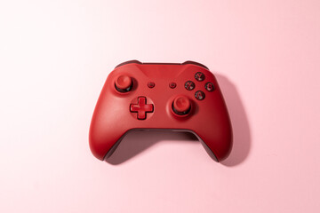 red joystick gamepad, game console on pink colourful trendy modern fashion pin-up background. Computer gaming competition videogame control © TropicalNinjaStudio
