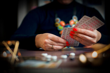 Tarot reader or fortune teller holding tarot cards