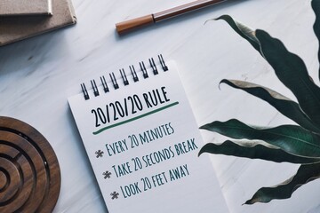20-20-20 rule to prevent digital eye strain concept and key points on notepad. Top view. 