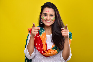 portraits of happy young woman celebrating holi