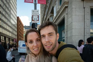 Fototapeten Selfie of a young couple under the sign of the start of route 66 © Adolf