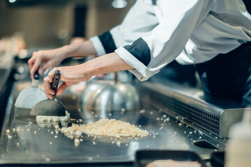 Hand of man take cooking of meat with vegetable grill, Chef cooking wagyu beef in Japanese teppanyaki restaurant