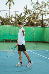 male tennis players concentrate on serving when playing on the tennis court