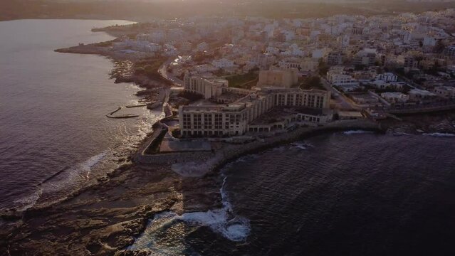 Drone shot landscape view of Jerma Palace Hotel in Marsaskala, sunset time, Malta