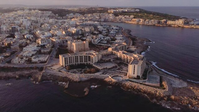 Drone shot landscape view of Jerma Palace Hotel in Marsaskala, sunset time, Malta