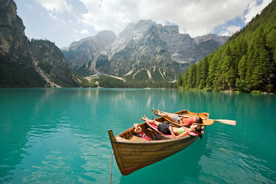 Couple in a row boat on the azure Lago di Braies