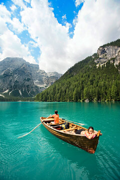 Couple in a row boat on the azure Lago di Braies