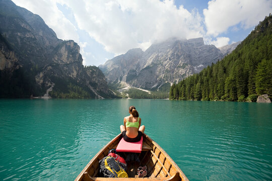 Woman relaxing in a row boat in the Italian Dolomites