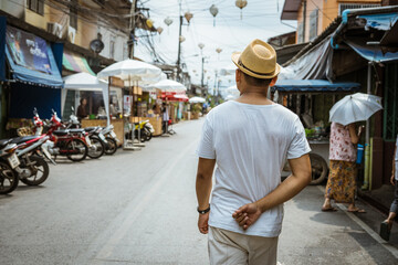 Asian Man walk in Thai market 