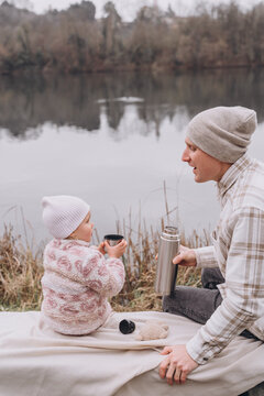 Picnic with dad in the park in early spring