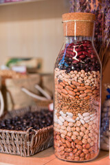 A bottle of beans and other grains is filled with beans and other grains.