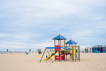 Children playground on public beach. Slide and climbing frames.