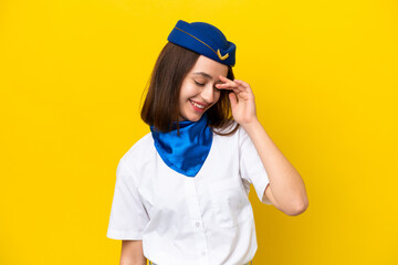 Airplane stewardess Ukrainian woman isolated on yellow background laughing