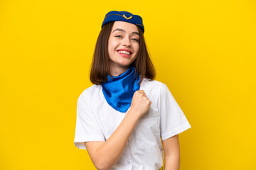 Airplane stewardess Ukrainian woman isolated on yellow background celebrating a victory