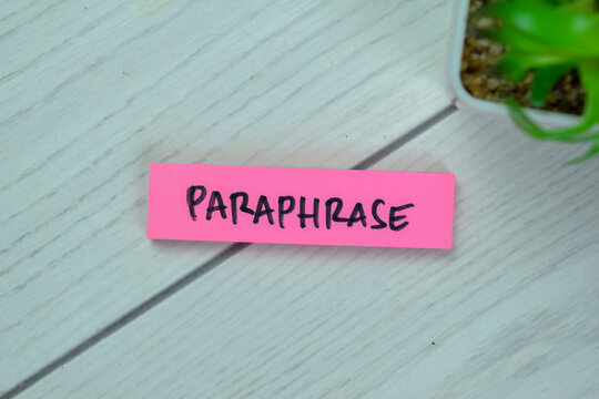 Concept of Paraphrase write on sticky notes isolated on Wooden Table.