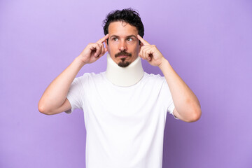 Young caucasian man wearing neck brace isolated on purple background having doubts and thinking