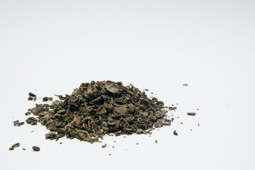 Heap of dry green tea isolated on white background