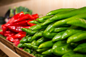 A shelf of vegetables in a store with a variety of vegetables.