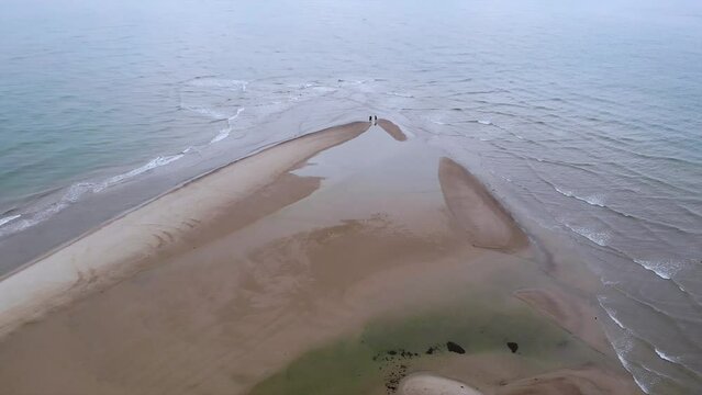Drone Over People Walking Along Grenen Sandbar