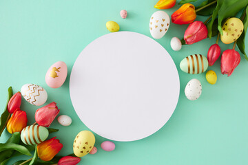 Easter decoration concept. Flat lay photo of white circle red tulips flowers and colorful eggs on isolated turquoise background with blank space. Holiday card idea - obrazy, fototapety, plakaty
