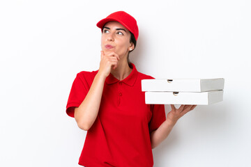 Pizza delivery caucasian woman with work uniform picking up pizza boxes isolated on white...