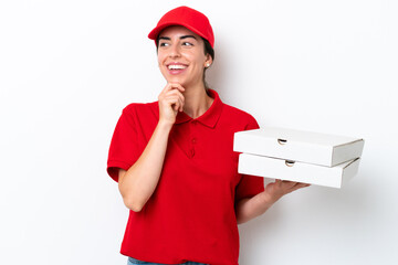 Pizza delivery caucasian woman with work uniform picking up pizza boxes isolated on white...