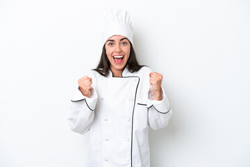 Young chef woman over white background celebrating a victory in winner position